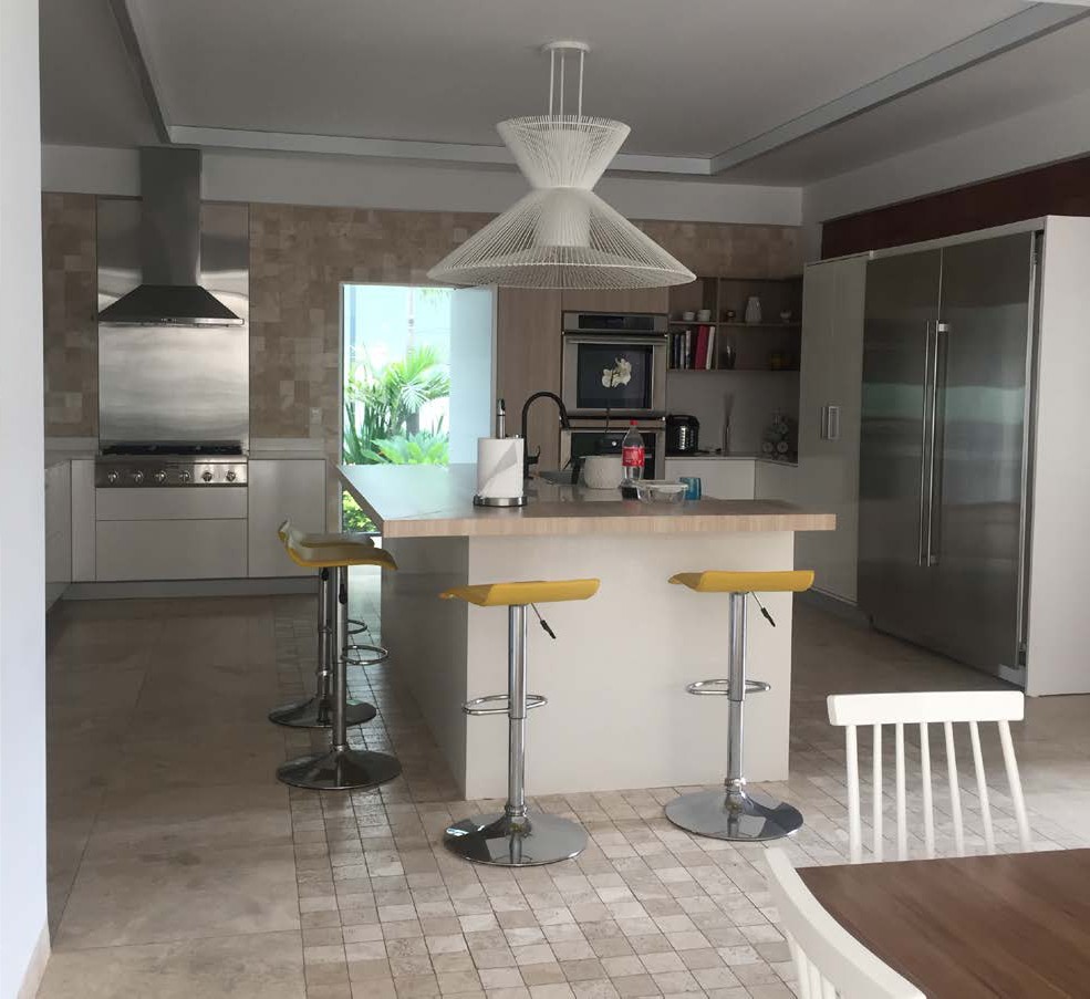 Open kitchen with island and travertine floor