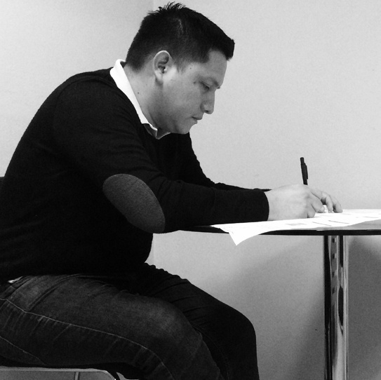 Miguel Valdez sketching at his desk